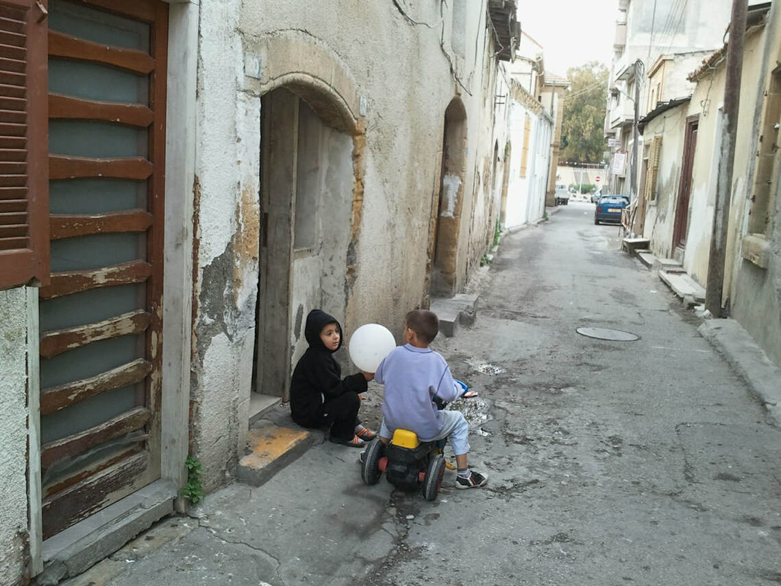 Two young kids having a chat in the run down streets of Lefkosa
