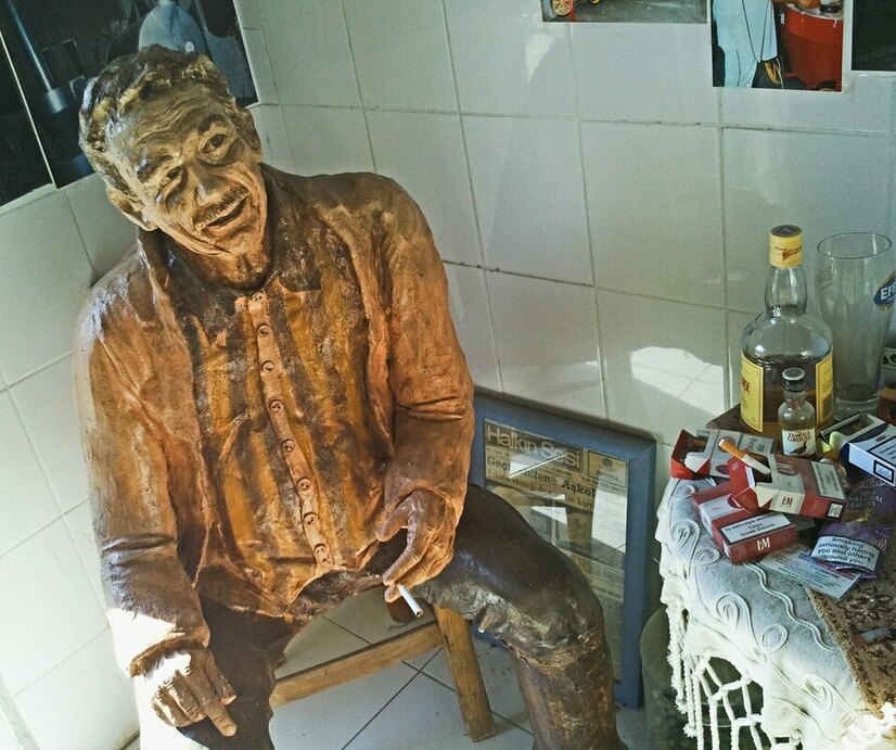 A Turkish Cypriots plastercast father with cigarettes and alcohol.