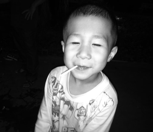 A happy kid with a lollipop, Kids of Hanoi, Streetphotography