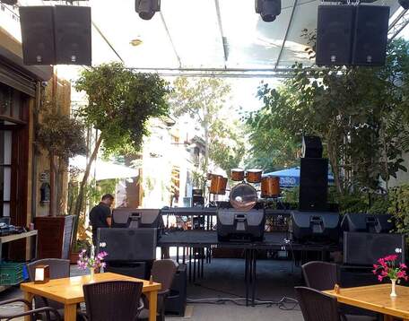 A Live sound stage setup with the drum kit facing backwards at the Bibliotheque Restaurant Bar, Live Venue