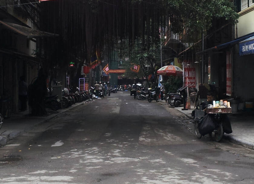 Dark streets from the overhanging trees in the streets of Hanoi, Aviewscene, Vietnam. Make a donation to the site to help it progress.