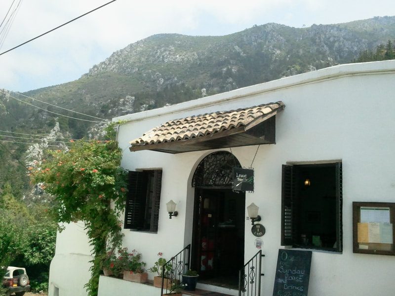 The restaurant in Karmi with the Five fingers mountain range in the background, Besparmak/ Pentadaktylos